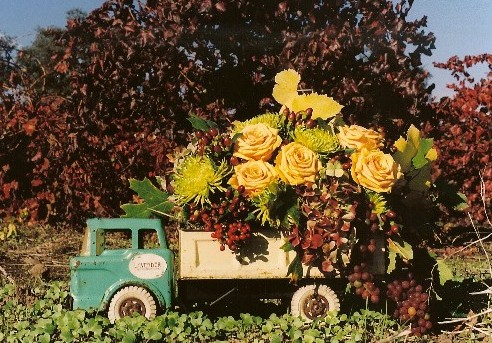 Toy dump truck with yellow roses.